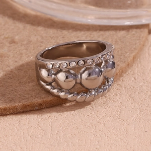 Macro shot of silver multi-layered ring with crystals, beads and twisted texture details