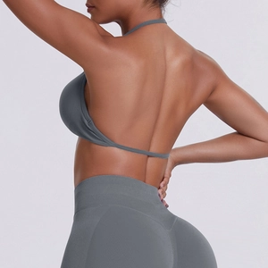 Detail of dark grey halter sports bra and high-waist seamless leggings showing back cutout