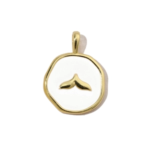 Detailed macro view of a gold-plated circular pendant with white enamel and a fish tail design