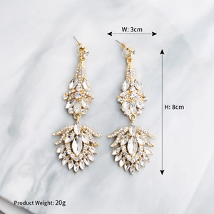 Macro shot of luxury rhinestone tassel earrings showing 3cm width and 8cm height dimensions