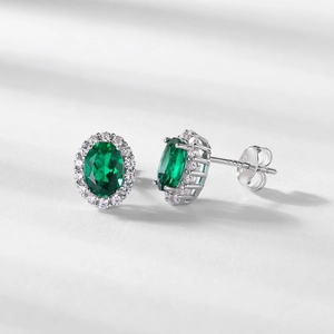 Elegant S925 silver oval emerald stud earrings surrounded by sparkling white zircons