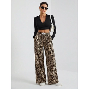 Close-up of leopard print high waist wide leg trousers paired with black crop top