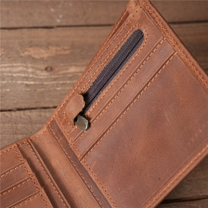 Interior detail of vintage brown leather wallet featuring card slots and zipper coin pocket