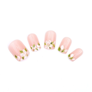 Pink press-on nails with white flower and green leaf hand-painted floral designs