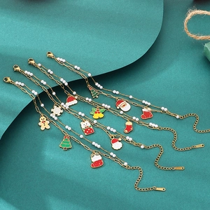 Detailed view of four Christmas charm bracelets with gold finish and enamel pendants