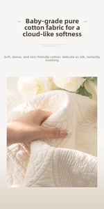 Detail of high-quality cream white quilted cotton fabric showing soft texture and stitching