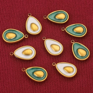 Detailed view of an 18K gold plated avocado pendant with green oil drip finish