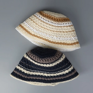 Detail of hand-crocheted bucket hats showing breathable striped woven texture and patterns