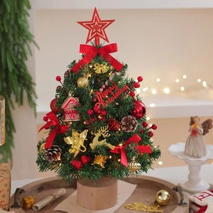 Detailed view of tabletop Christmas tree with red bows, ornaments and wood base