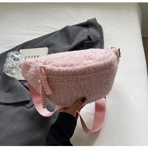 Detail view of the pink teddy fleece texture and adjustable strap on this crossbody bag