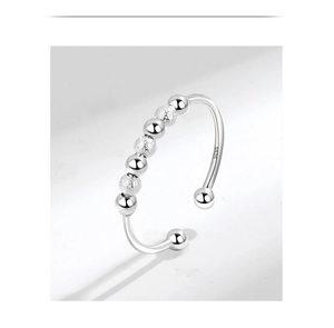 Macro shot of S925 sterling silver spinning beads on adjustable anxiety relief ring