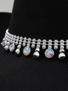 Macro view of silver cowboy hat band featuring iridescent rhinestones and metal spikes