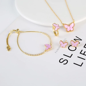 Close-up of pink butterfly jewelry set including gold necklace, bracelet, ring and earrings
