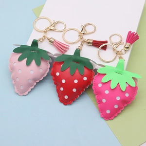 Three strawberry leather keychains in pink red and rose with gold hardware and tassels