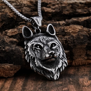 Retro stainless steel wolf head pendant necklace displayed on natural dark tree bark