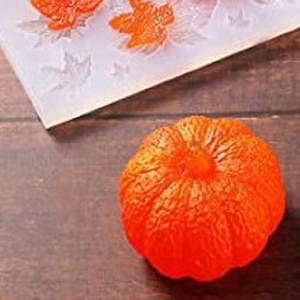 Macro detail of pumpkin silicone mold and finished orange pumpkin with realistic texture
