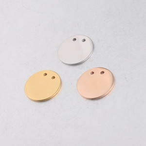 Close-up of 21mm round double-hole stainless steel tags in silver, gold and rose gold