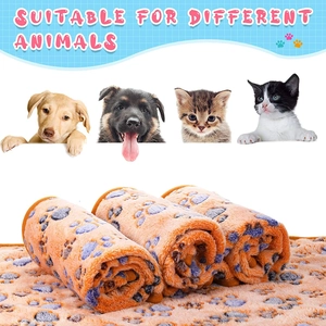 Detail of soft orange flannel pet blanket with purple paw prints for dogs and cats