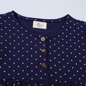 Girls dark blue polka dot dress with long sleeves and three wooden buttons detail