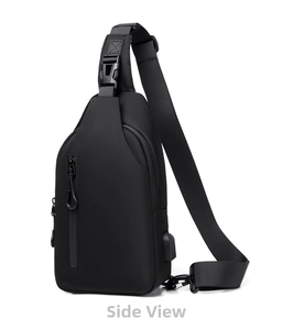 Detail view of black nylon chest bag with USB charging port and adjustable strap buckle
