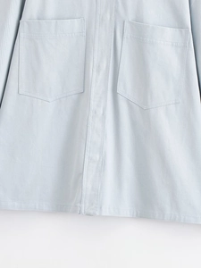 Detail of light blue twill fabric shirt with two large symmetrical flap pockets