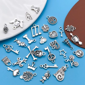 Detailed close-up of mixed silver alloy charms in various shapes for DIY jewelry making