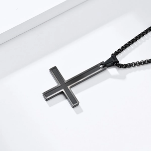 Macro shot of black inverted cross pendant with matte center and polished box chain