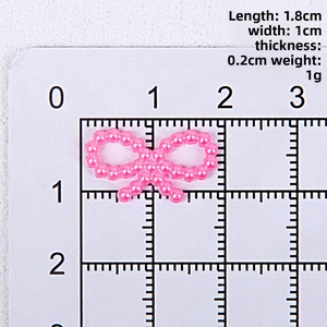 Macro shot showing dimensions of pink ABS pearl bow decoration for DIY crafts and decor