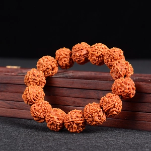 Nepal Rudraksha beads bracelet with 5-faced seeds on a vintage wooden box background