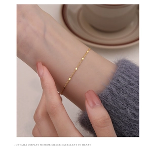 Close-up of minimalist gold-plated S925 silver bracelet with mirror-polished sequins