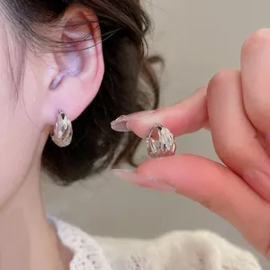 Minimalist silver pleated C-shaped stud earrings with sparkling diamond-cut texture