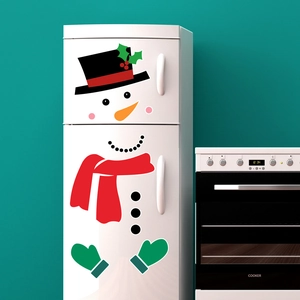 Detail of Christmas snowman magnetic stickers showing colorful scarf and carrot nose on fridge