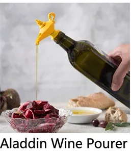 Close-up of a yellow Aladdin lamp wine pourer plugged into a dark glass bottle neck