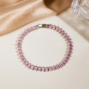 Detail of pink marquise-cut zircon tennis bracelet with silver-tone metal folding clasp