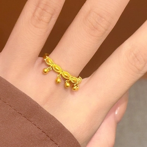 Elegant gold bead tassel ring for women worn on finger featuring a minimalist charm design