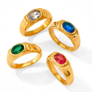 Macro shot of vintage gold-plated wide rings with colorful oval zircon gemstones