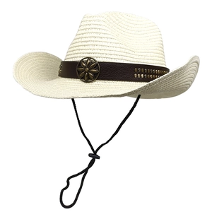 Detail of straw cowboy hat with decorative leather band and vintage bronze floral emblem