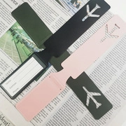 Close-up of three colorful luggage tags with name, address, and phone info fields