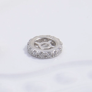 Macro shot of S925 sterling silver bead with double-row cubic zirconia and S925 hallmark