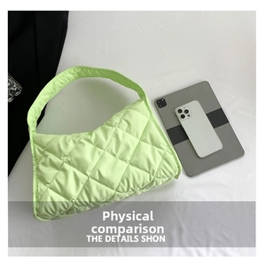 Quilted light green tote bag detail showing padded nylon texture compared with tablet