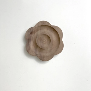 Detailed macro view of a flower shaped wooden tray showing natural wood grain texture