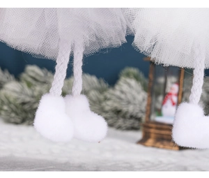 Close-up of doll's legs with white woven ropes, plush boots, and soft mesh skirt detail