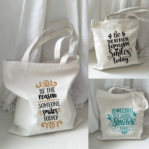 Detailed views of canvas tote bag stitching and motivational quote print texture