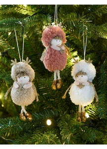 Detailed view of plush reindeer ornaments hanging on a Christmas tree with warm lights