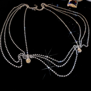 Close-up of multilayer silver body chain featuring rhinestones and water drop pendants