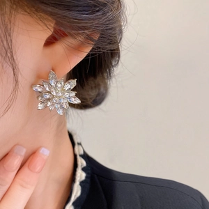 Exquisite flower stud earrings with marquise crystal petals worn by a model