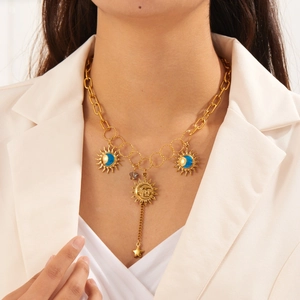 Gold bohemian necklace with sun moon and star pendants featuring blue enamel details