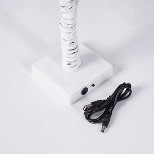 Detail of the white square base with USB power cable and switch for birch tree lamp