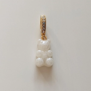 Detail of white glitter gummy bear pendant with gold rhinestone clasp for necklace