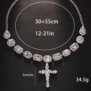 Sparkling silver cross pendant necklace with rhinestones on a sleek black background